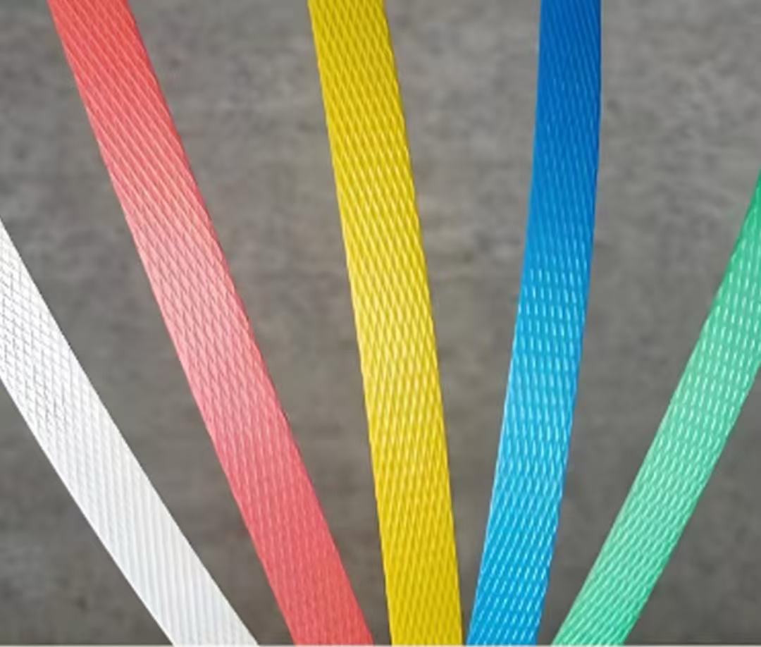 Close-up photo of colored PP strapping bands arranged side by side.